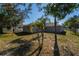 This spacious backyard is perfect for outdoor entertaining and activities with lush green grass at 1632 Lansfield Ave, Deltona, FL 32738