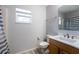 Bathroom with wood vanity and shower with window at 1632 Lansfield Ave, Deltona, FL 32738