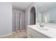 Bathroom with white single vanity, tiled floor, and glass enclosed shower at 1632 Lansfield Ave, Deltona, FL 32738