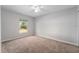 Empty bedroom with a large window, neutral paint, and plush carpet at 1632 Lansfield Ave, Deltona, FL 32738