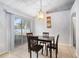 Bright dining area with modern light fixture and sliding glass door to backyard at 1632 Lansfield Ave, Deltona, FL 32738