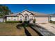 Inviting single-story home featuring well-maintained landscaping and a two-car garage at 1632 Lansfield Ave, Deltona, FL 32738
