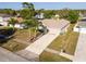 This charming home boasts a well-maintained lawn, mature palm trees, and a paved driveway at 1632 Lansfield Ave, Deltona, FL 32738