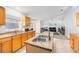 Well-lit kitchen featuring an island with a sink, wooden cabinets, and an open layout at 1632 Lansfield Ave, Deltona, FL 32738