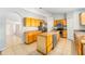 Bright kitchen featuring wooden cabinetry, stainless steel appliances, and an island at 1632 Lansfield Ave, Deltona, FL 32738