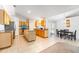 Open-concept kitchen featuring an island, stainless steel appliances, and a dining area at 1632 Lansfield Ave, Deltona, FL 32738