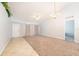 Bright living room featuring tile and carpet floors, ample natural light, and a modern ceiling fan at 1632 Lansfield Ave, Deltona, FL 32738
