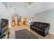 Cozy living room with an open view to the kitchen, featuring carpet and modern furniture at 1632 Lansfield Ave, Deltona, FL 32738