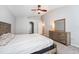 Bright main bedroom features carpeted floors, vaulted ceiling, and a dresser with mirror at 1632 Lansfield Ave, Deltona, FL 32738