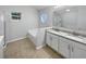 Bathroom featuring double sinks, granite counters, a soaking tub and a separate shower at 1730 Lochshyre Loop, Ocoee, FL 34761