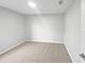 Bright bedroom features neutral carpet, a skylight, and minimalist walls for a serene and customizable space at 1730 Lochshyre Loop, Ocoee, FL 34761