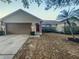 Charming single Gathering home boasts a two-car garage and inviting front yard at 1730 Lochshyre Loop, Ocoee, FL 34761