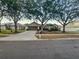 Charming single-story home with mature trees, a well-manicured lawn, and a two-car garage at 1730 Lochshyre Loop, Ocoee, FL 34761