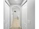 Bright hallway showcasing tile flooring and white closet doors leading to other rooms at 1730 Lochshyre Loop, Ocoee, FL 34761