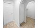Hallway with tile floors, storage and an arched alcove at 1730 Lochshyre Loop, Ocoee, FL 34761