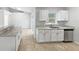 Bright kitchen showcasing granite countertops, stainless steel appliances and neutral tile flooring at 1730 Lochshyre Loop, Ocoee, FL 34761