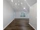 Spacious living room with ample natural light, modern lighting fixture, and dark hardwood flooring at 1730 Lochshyre Loop, Ocoee, FL 34761