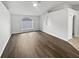 Bright living room features wood floors, vaulted ceiling, and a beautiful window at 1730 Lochshyre Loop, Ocoee, FL 34761