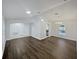 Open living room featuring hardwood flooring, recessed lighting, and seamless transition to kitchen area at 1730 Lochshyre Loop, Ocoee, FL 34761