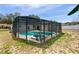 Enclosed pool with a hot tub in a large screened in area and view of the yard at 1730 Lochshyre Loop, Ocoee, FL 34761