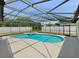 Screened-in pool and spa overlook the backyard, providing a relaxing outdoor living space at 1730 Lochshyre Loop, Ocoee, FL 34761