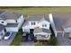 Aerial view of a home with a two-car garage, brick driveway, manicured lawn at 18907 Rawson St, Orlando, FL 32827
