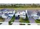 Aerial view of a home with a two-car garage, brick driveway, manicured lawn at 18907 Rawson St, Orlando, FL 32827