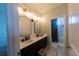 Bathroom featuring double vanity, modern lighting, and stylish arched mirrors at 18907 Rawson St, Orlando, FL 32827