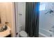 Bathroom including white tiled bath and shower combo with a dark green curtain at 18907 Rawson St, Orlando, FL 32827