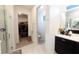 Bright bathroom featuring glass shower, open closet and vanity at 18907 Rawson St, Orlando, FL 32827