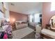 Cozy bedroom with daybed, white trim, natural light, and neutral-toned walls at 18907 Rawson St, Orlando, FL 32827