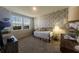 Cozy bedroom features an accent wall with matching patterned wall paper at 18907 Rawson St, Orlando, FL 32827