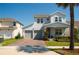 Charming two-story home with a two-car garage, brick driveway, manicured lawn, and covered front porch at 18907 Rawson St, Orlando, FL 32827