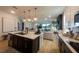 A modern kitchen island features a sink, while the open floor plan seamlessly connects to the cozy living room at 18907 Rawson St, Orlando, FL 32827