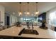 Modern kitchen with large island sink, seamlessly connects to the living area and cozy fireplace at 18907 Rawson St, Orlando, FL 32827
