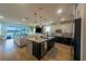 Open kitchen with stainless steel appliances, large island, and seamlessly flowing into the living area at 18907 Rawson St, Orlando, FL 32827