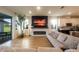 Open-concept living room with a fireplace and sliding glass doors to the patio at 18907 Rawson St, Orlando, FL 32827