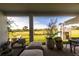 Outdoor seating on patio with view of large backyard and playhouse at 18907 Rawson St, Orlando, FL 32827