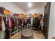 Spacious walk-in closet featuring organization system, shelves and ottoman at 18907 Rawson St, Orlando, FL 32827