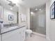 Modern bathroom features a glass-enclosed shower, granite countertop and sleek fixtures at 2 Oceans West Blvd # 2006, Daytona Beach Shores, FL 32118