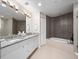 Contemporary bathroom with double sinks, tub, and modern lighting at 2 Oceans West Blvd # 2006, Daytona Beach Shores, FL 32118