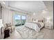 Bright bedroom with a sliding glass door to a balcony and ocean views at 2 Oceans West Blvd # 2006, Daytona Beach Shores, FL 32118