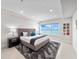 Modern bedroom with area rug offers water view with bright lighting and minimal decor at 2 Oceans West Blvd # 2006, Daytona Beach Shores, FL 32118
