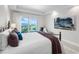 Bright bedroom featuring a balcony with stunning waterfront views and stylish decor at 2 Oceans West Blvd # 2006, Daytona Beach Shores, FL 32118
