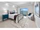 Modern bedroom with wrought iron bed frame, water view, plush rug, and blue accent color at 2 Oceans West Blvd # 2006, Daytona Beach Shores, FL 32118