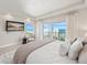 Bedroom with balcony access, ocean views, and a mounted television at 2 Oceans West Blvd # 2006, Daytona Beach Shores, FL 32118