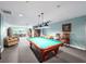 Cozy billiards room with a well-maintained pool table, seating, and bookshelves at 2 Oceans West Blvd # 2006, Daytona Beach Shores, FL 32118