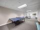 Well-lit game room with ping pong tables and seating for entertainment and recreation at 2 Oceans West Blvd # 2006, Daytona Beach Shores, FL 32118