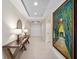 Bright condo hallway with modern console table and decor leading to double entry doors at 2 Oceans West Blvd # 2006, Daytona Beach Shores, FL 32118