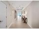 Inviting condo hallway featuring neutral tones, stylish console table, and ocean view at the end at 2 Oceans West Blvd # 2006, Daytona Beach Shores, FL 32118